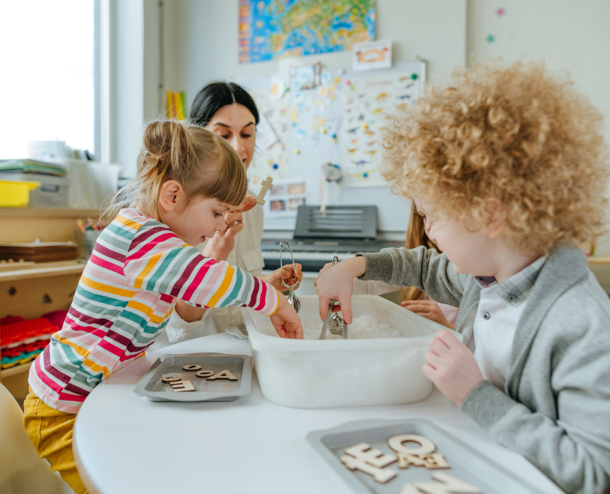 Children's playing with a teacher on kids classroom
