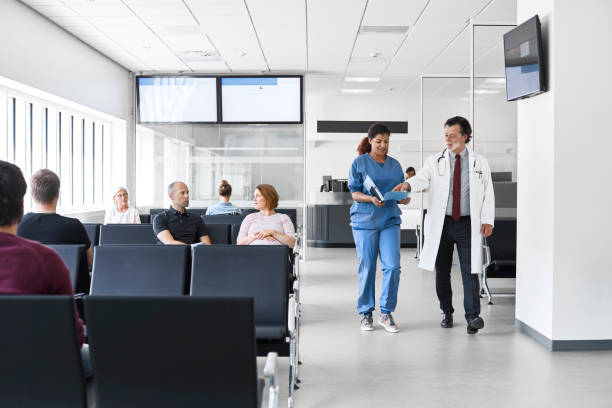 image of doctor walking of lobby with a nurse holding documents