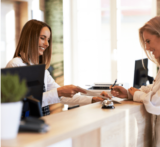Receptionist accepting the paper from the customer