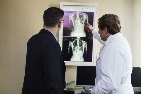 doctor showing x ray result to his patient