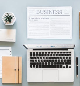 laptop with business newspaper