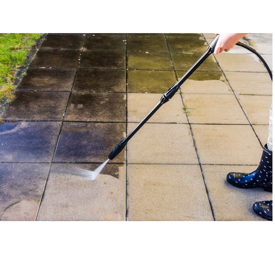 person cleaning the tiles with water pressure