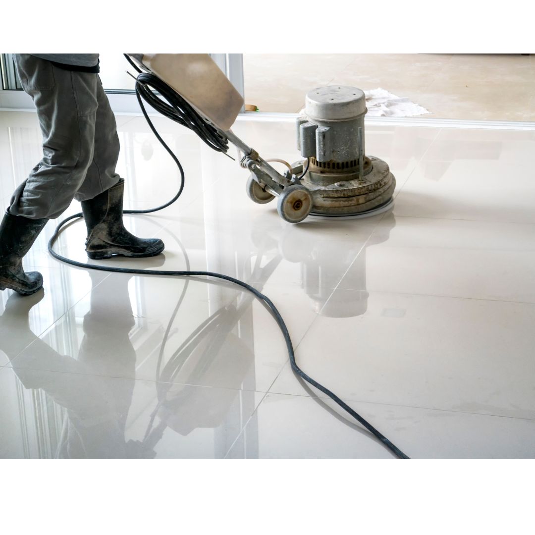 person cleaning the tiles with mop