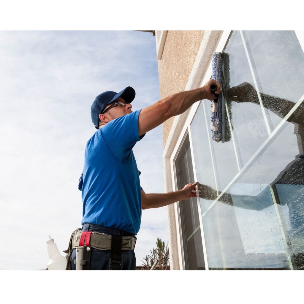 person cleaning the outside windows