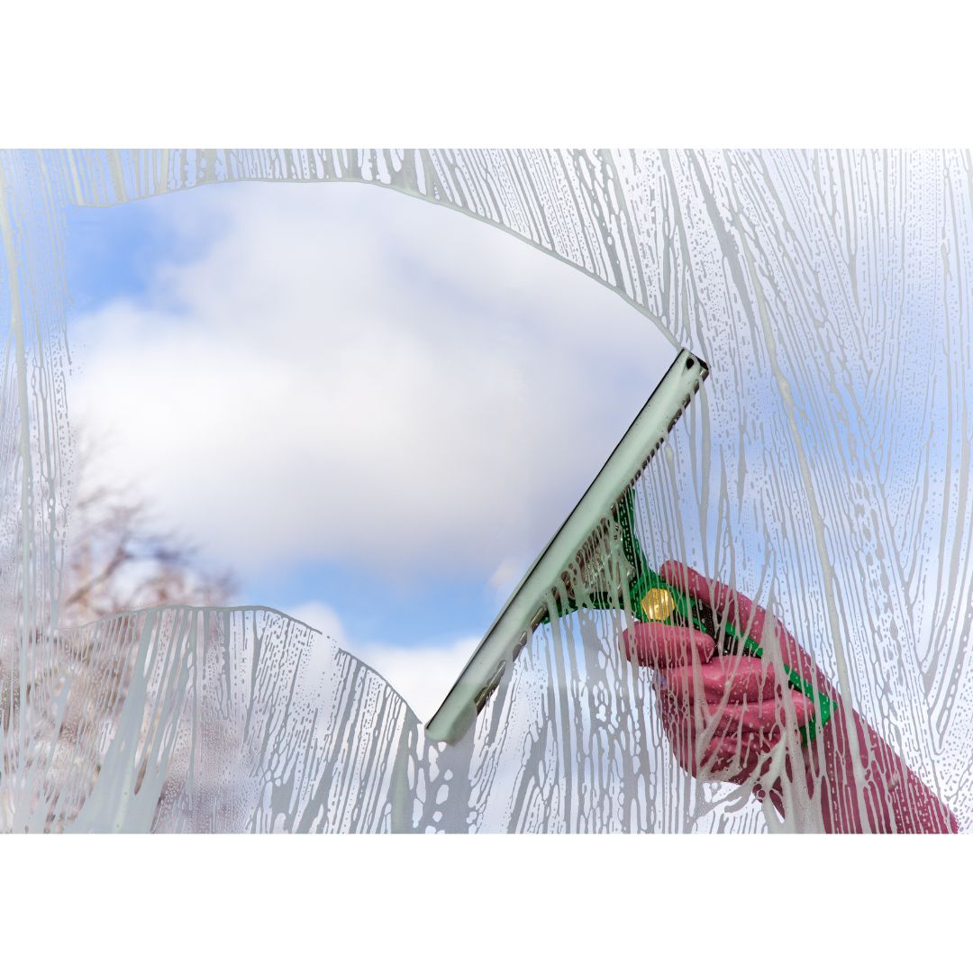 person cleaning the glass window