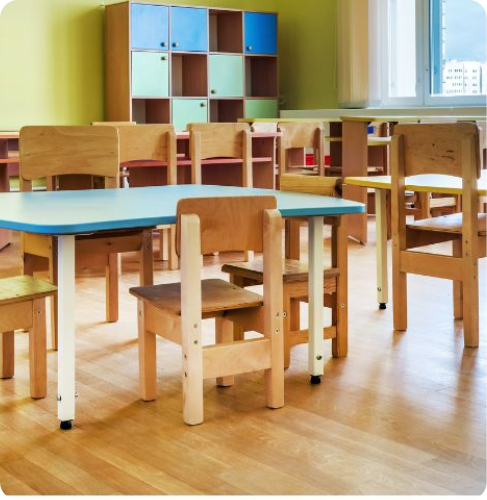 kids classroom with wooden table and chairs