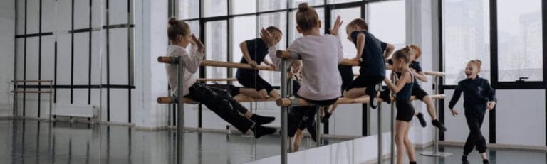 Children hanging on a bar and training