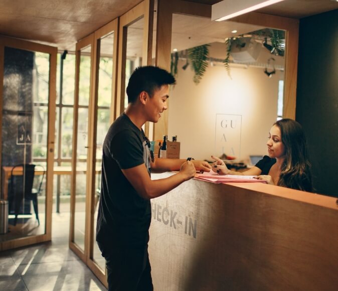 Image of a receptionist talking to a male Customer