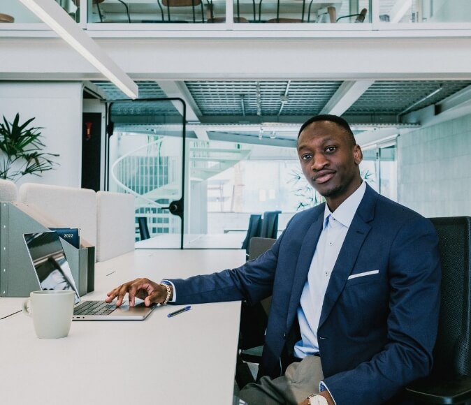 Image of a worker in suite using laptop