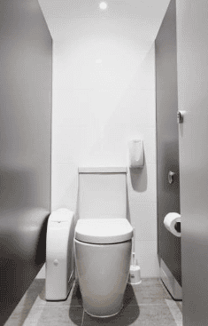 Clean, modern commercial bathroom with white fixtures and grey walls.